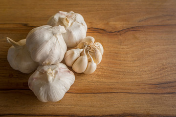 The garlic on wood Table in kitchen close up image