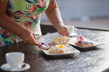 Obraz na płótnie Canvas Grandmother preparing waffles for breakfast