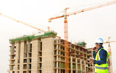 Engineer supervising building construction.