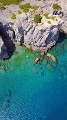 August 2017: Aerial drone photo of paradise beach of Traganou with small caves and turquoise clear waters, Rhodes island, Dodecanese, Aegean, Greece