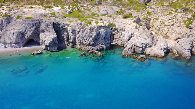 August 2017: Aerial drone photo of paradise beach of Traganou with small caves and turquoise clear waters, Rhodes island, Dodecanese, Aegean, Greece