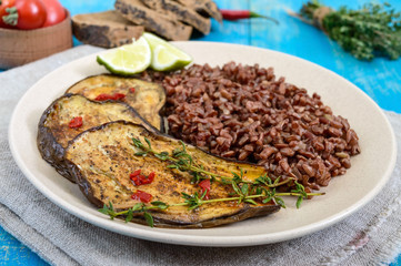 Baked slices of eggplant, butane red rice. Proper nutrition. Asian cuisine.