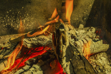 beech log burning in barbecue with nice warm yellow flame