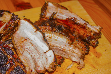 pork ribs marinated grilled on charcoal barbecue and cutted on wooden board close-up