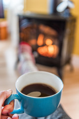 Cozy fireplace autumn woman drinking coffee