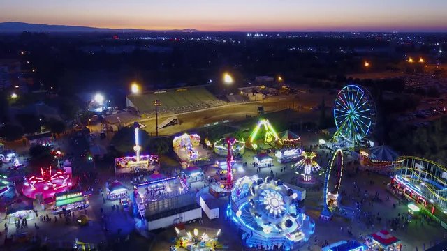 County Fair Rides Lights and Carnival Games at Sunset 