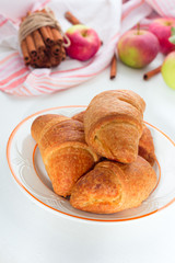 Naklejka na ściany i meble Fresh croissant on light wooden background. Place for text, copy space. Flat lay. Top view
