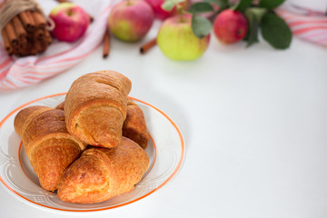 Fresh croissant on light wooden background. Place for text, copy space. Flat lay. Top view