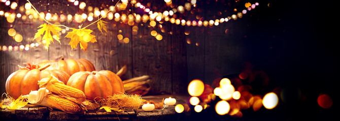 Thanksgiving Day background. Wooden table decorated with pumpkins and corncobs