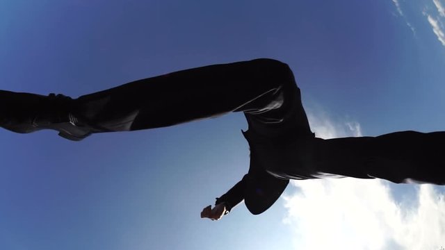 スロー　ガッツポーズでジャンプする　ビジネスマン　タテ・ヨコ汎用素材　青空コピースペース