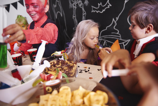 Children Sharing Food At Halloween Party
