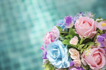 Beautiful colorful flower bouquet over blurred blue water background