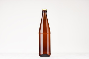 Brown NRW beer bottle  500ml mock up. Template for advertising, design, branding identity on white wood table.