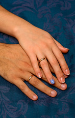 Fototapeta premium Photo of hands with beautiful wedding rings on blue background