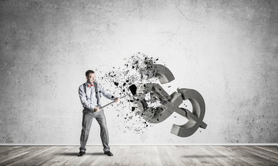 Determined banker man in empty concrete room breaking dollar fig
