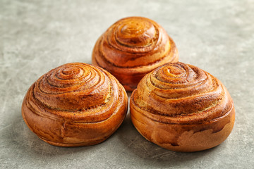 Sweet cinnamon rolls on gray table