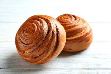 Sweet cinnamon rolls on wooden table
