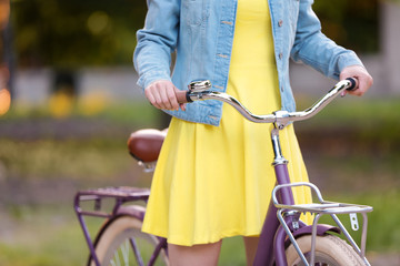 Beautiful young woman with bicycle, outdoors