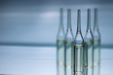 transparent vials of medicine