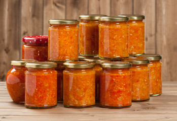 Fototapeta na wymiar Homemade Preserve With Sweet And Hot Peppers, Tomatoes, Garlic, Carrots. Traditional Adjika Dip.