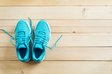 blue sneakers on wooden floor