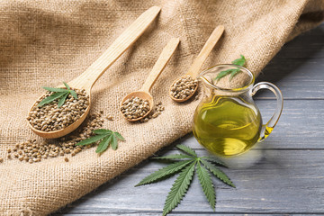 Composition with hemp oil in jug on table