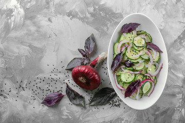 Fototapeta na wymiar Fresh cucumber salad in plate on table