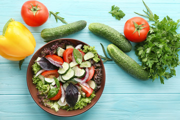 Vegetable salad with cucumbers in bowl on table