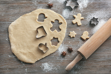 Composition with dough for Christmas cookies on wooden table