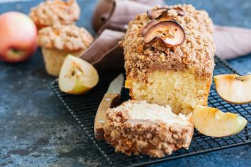 Apple cinnamon streusel cake on a wire rack on a blue stone background. View from above.