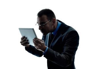 one caucasian business man standing using digital tablet  silhouette isolated on white background