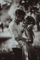 Black and white photo Young beautiful couple on a blurred natural background