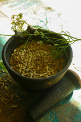 Cumin seeds in cast iron mortar