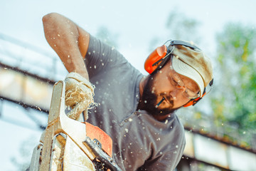 a man is sawing a log with a saw