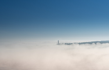 thick morning fog on the summer field. the dense forest on the horizon. Morning landscape in summer thick fog