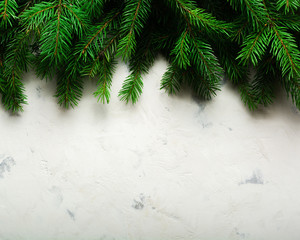 Christmas and New Year background. Christmas tree branch on a white background. A gift for the family. View from above.