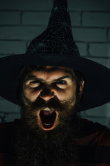 Halloween wizard with beard on evil face shouting