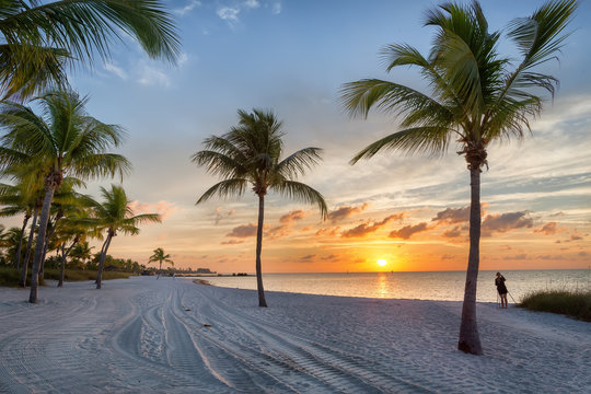 Photographer at sunrise on the Smathers beach - Key West, Florida - Powered by Adobe