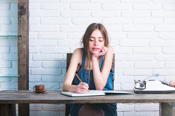 Girl writing with pencil in notebook