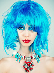 Girl with bright artificial hair in ethnic jewelry.