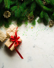 Christmas and New Year background. Christmas tree branch on a white background. A gift for the family. View from above.