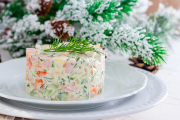 New Year's salad Olivier on a white plate, horizontal