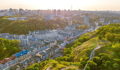 Aerial top view of Kyiv cityscape of Vozdvizhenka and Podol historical districts on sunset from...