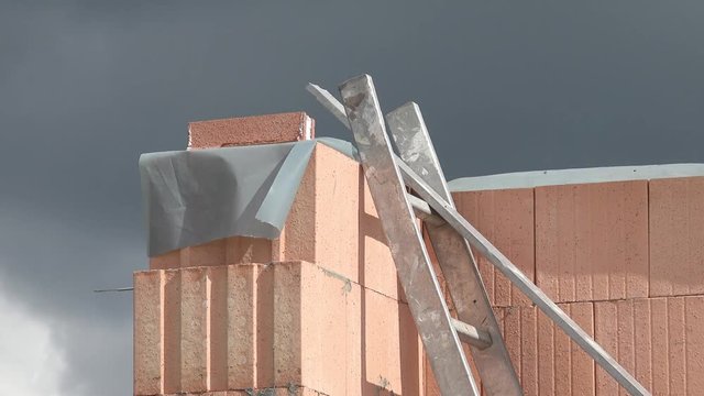 Ladder standing at brickwork 