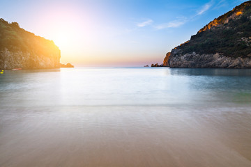Long exposure landscape of Paleokastritsa famous sand beach in close bay on Corfu island at dusk, Ionian archipelago, Greece.