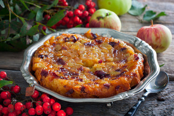 Inverted apple pie with cranberries, selective focus