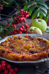 Inverted apple pie with cranberries, selective focus