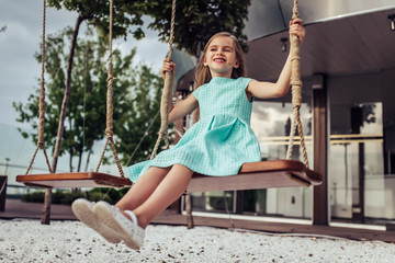 Little girl on swing