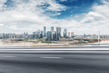 Fototapeta premium empty asphalt road with cityscape of modern city