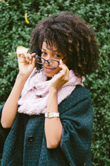 Stylish cheerful woman wearing eye glasses and fashion autumn clothes at the park.
